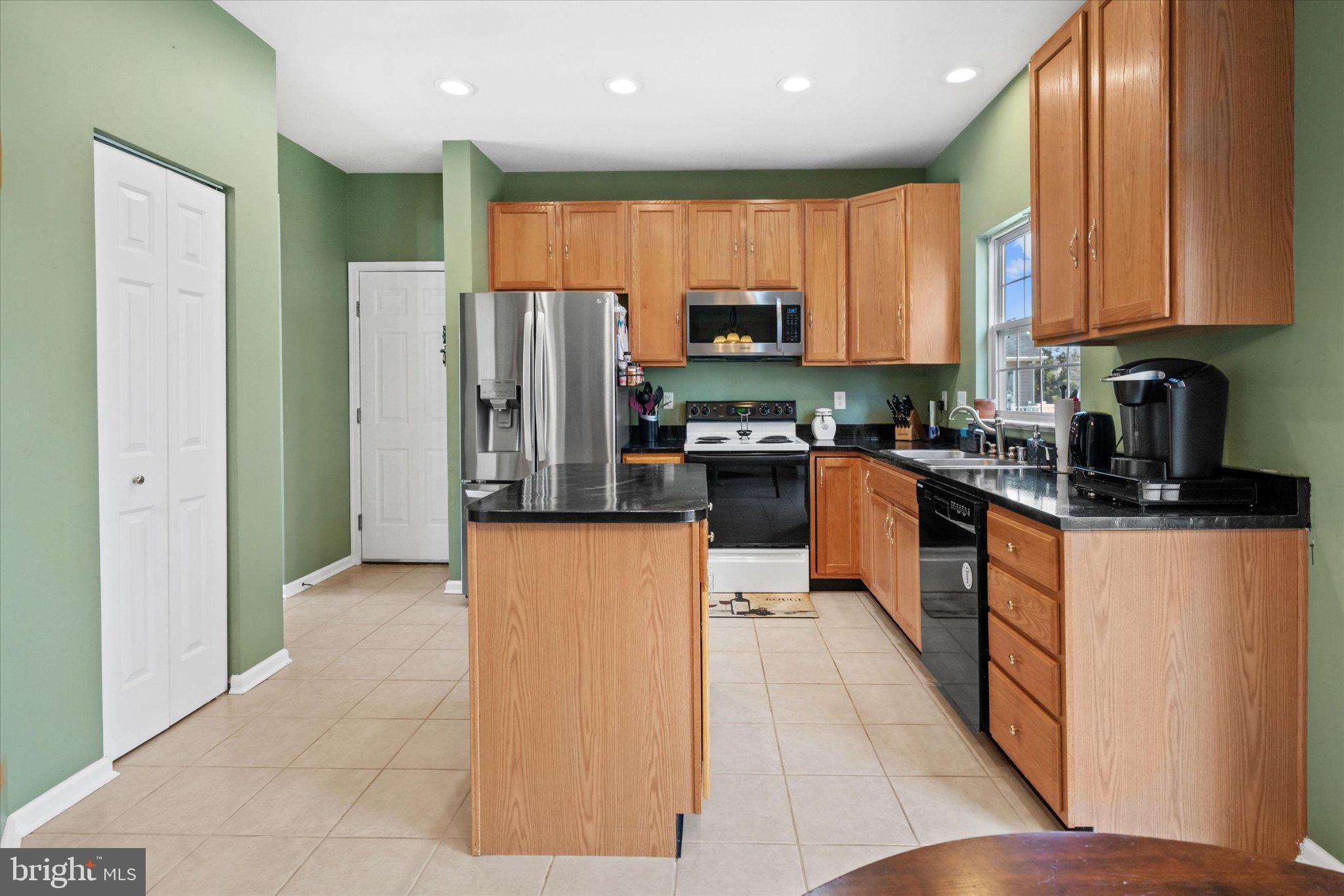 457 Preakness Run Newark, DE 19702 - Photo 31 of 55 a kitchen with stainless steel appliances granite countertop a refrigerator a stove top oven a sink and dishwasher