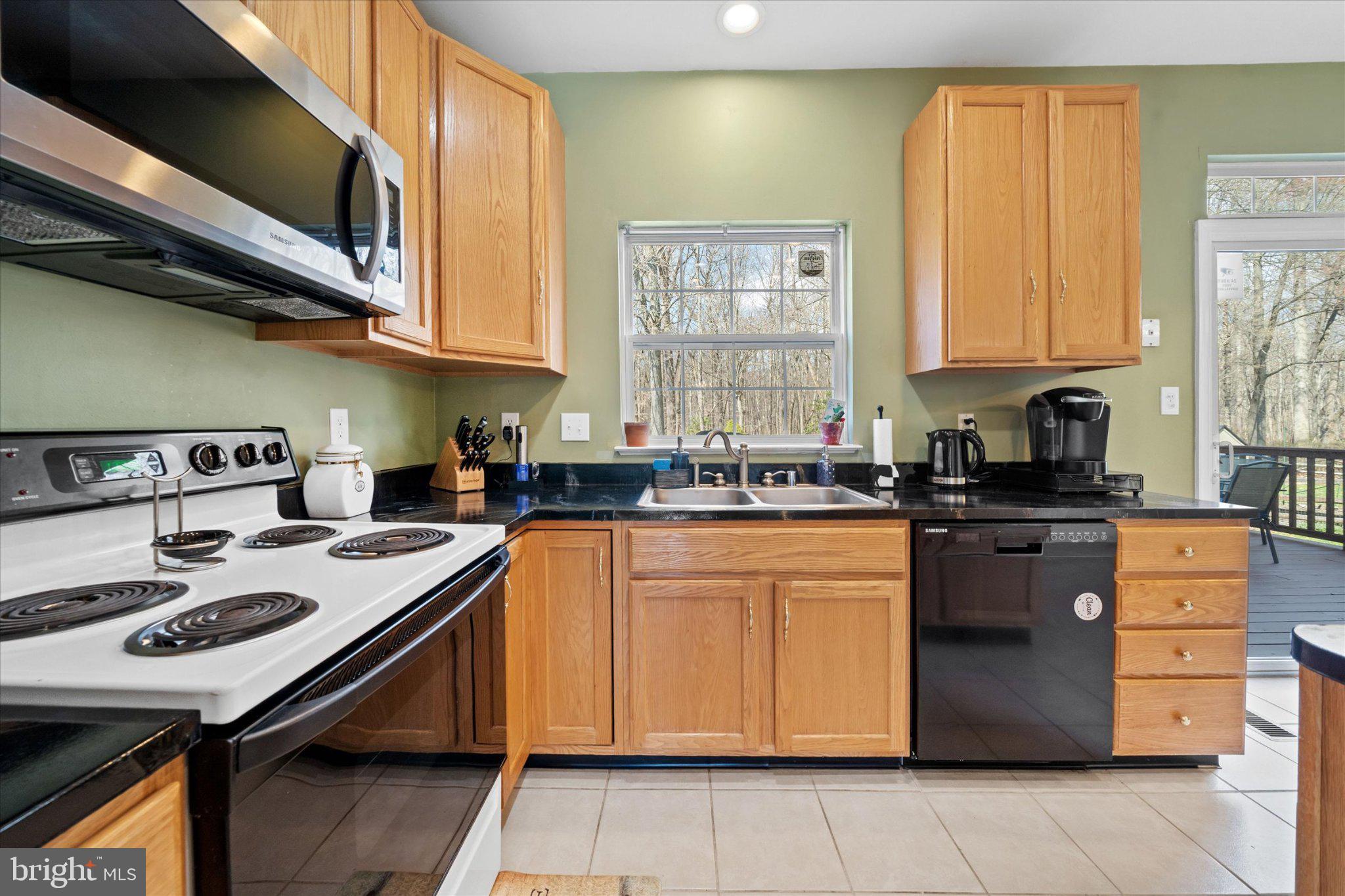 457 Preakness Run Newark, DE 19702 - Photo 34 of 55 a kitchen with stainless steel appliances granite countertop a stove a sink and a microwave
