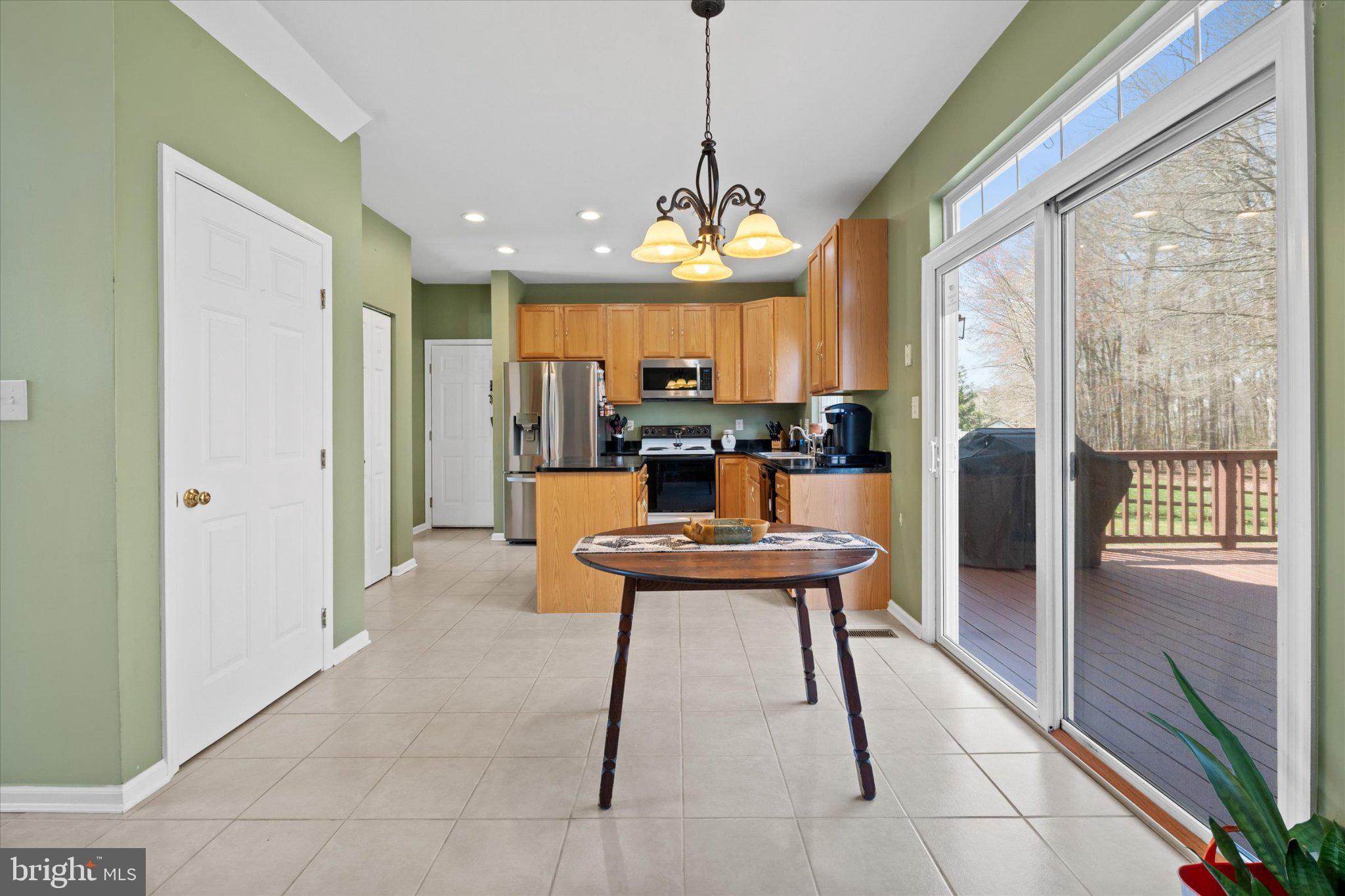 457 Preakness Run Newark, DE 19702 - Photo 38 of 55 a view of a dining room with furniture a chandelier and wooden floor