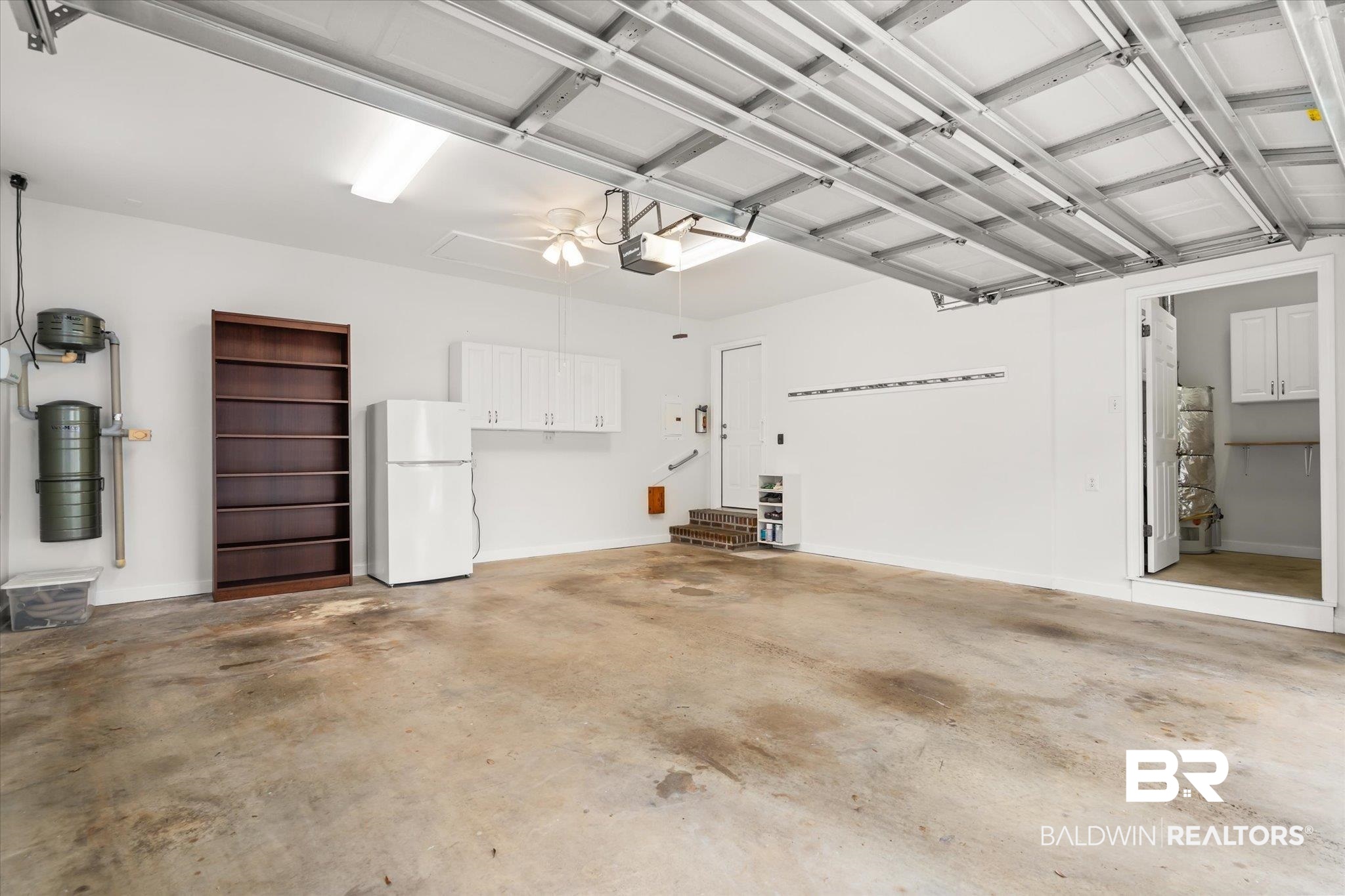 19924 Hunters Loop Fairhope, AL 36532 - Photo 28 of 40 Garage featuring white fridge and a garage door opener