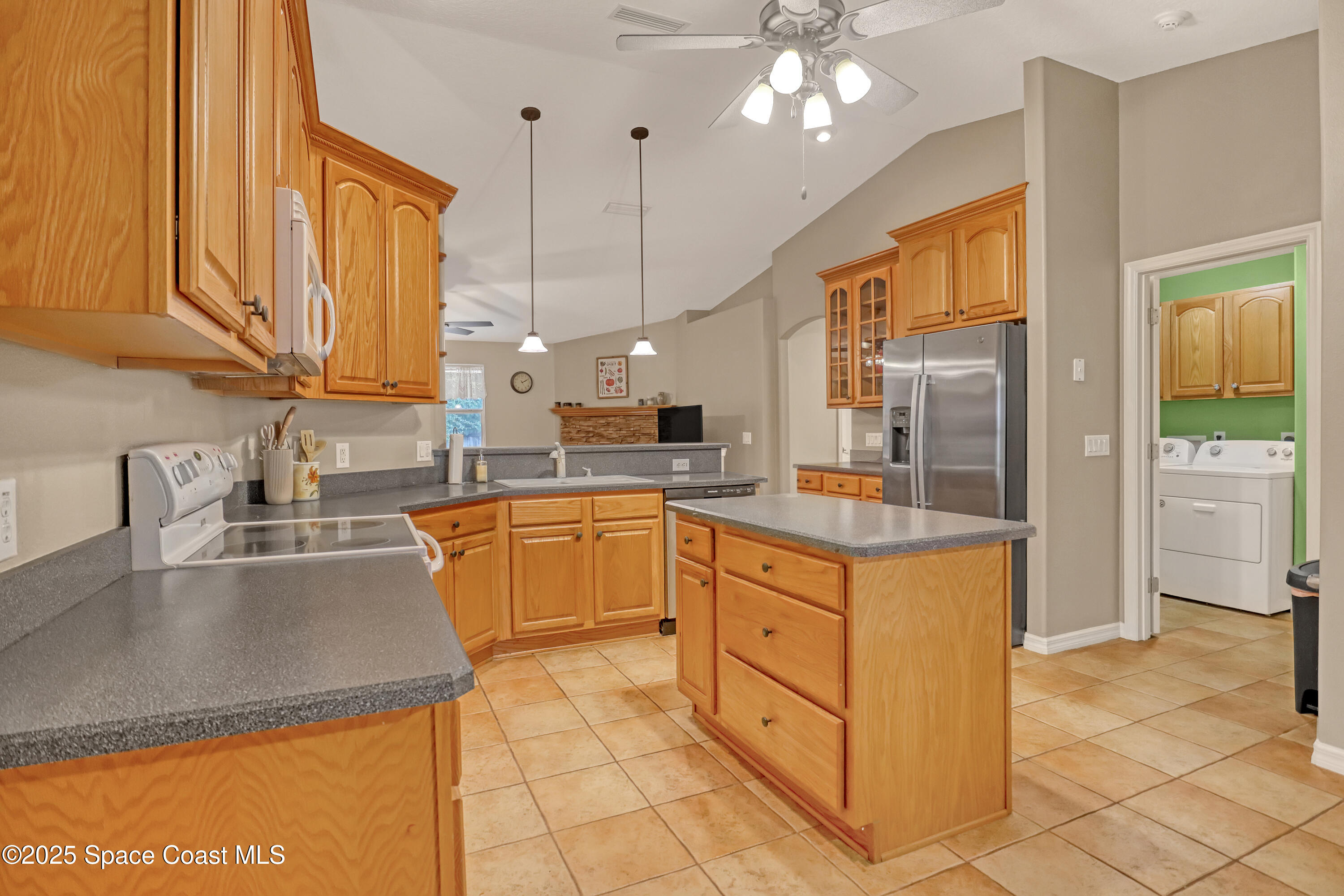 1081 Meadowbrook Road Northeast Palm Bay, FL 32905 - Photo 14 of 37 Kitchen, family room, laundry room