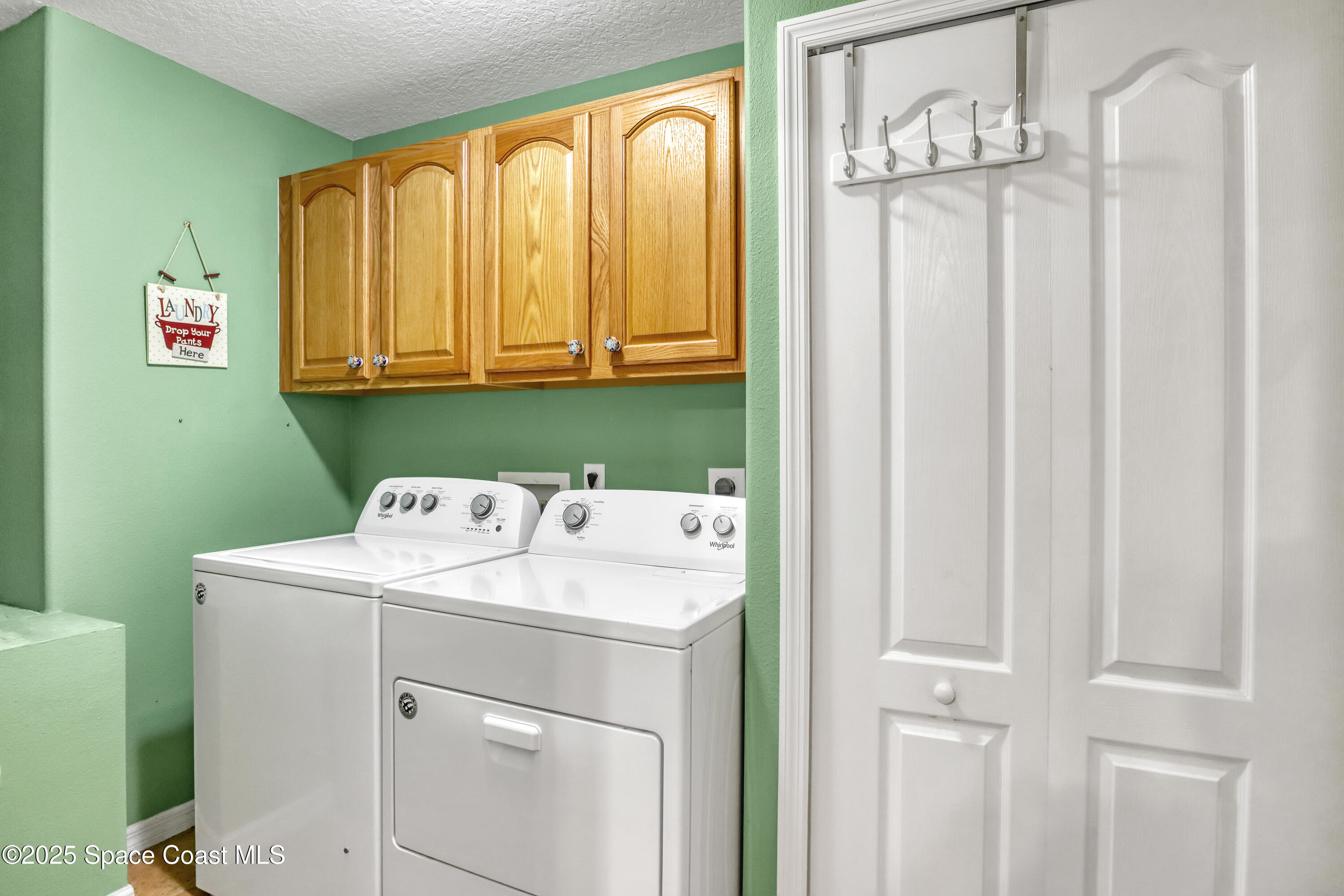 1081 Meadowbrook Road Northeast Palm Bay, FL 32905 - Photo 25 of 37 Laundry room with cabinets and storage