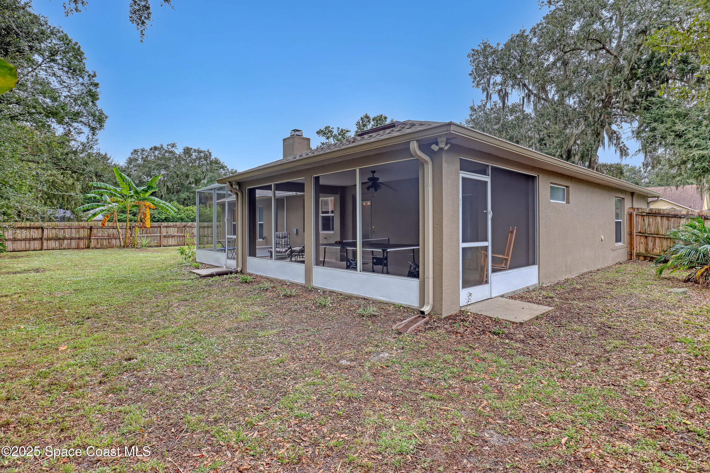 1081 Meadowbrook Road Northeast Palm Bay, FL 32905 - Photo 33 of 38 Backyard with screened porch