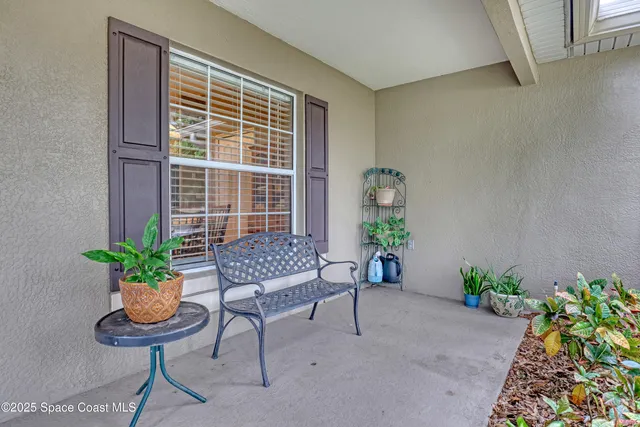 a living room with furniture a dining table and a lamp with kitchen view