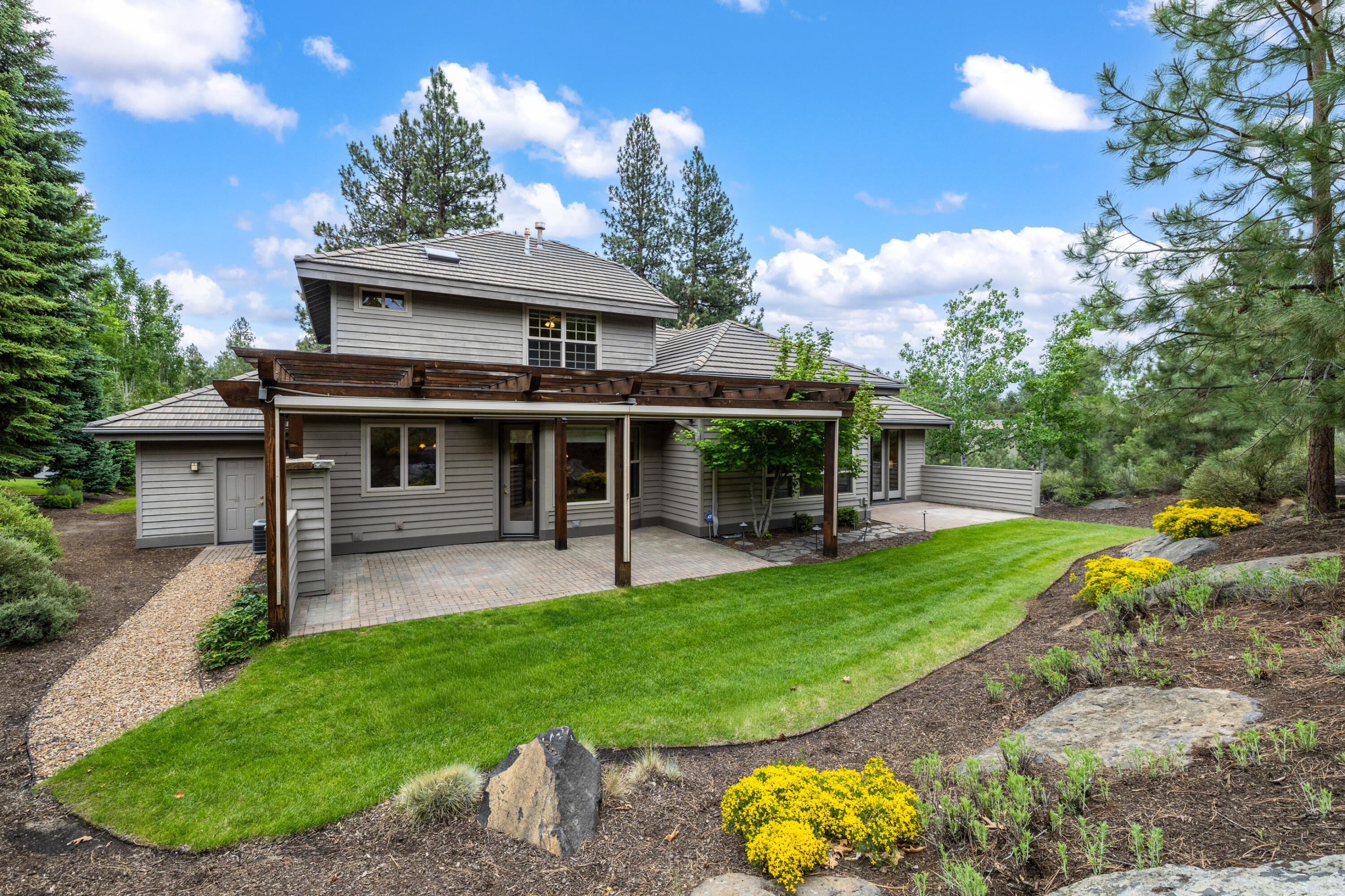 19598 Green Lakes Loop Bend, OR 97702 - Photo 61 of 89 a view of a house with a backyard porch and sitting area