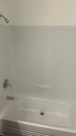 a bath tub sitting next to a white sink