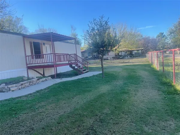 a view of a house with a yard and a slide