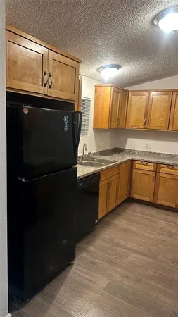 a kitchen with a sink appliances and cabinets