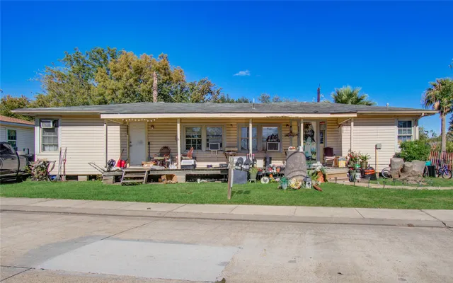 a view of a house with a yard and front view of a house