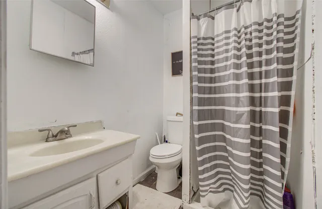 a bathroom with a sink toilet and shower