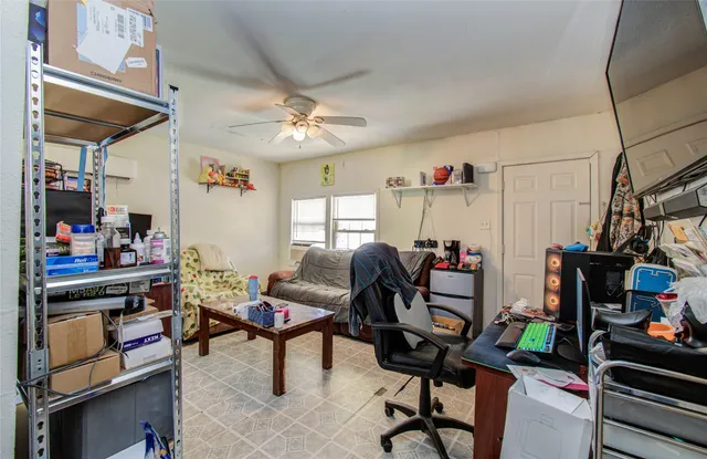 a view of a workspace with furniture and a window