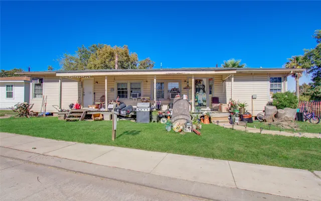 a view of a house with backyard sitting area and garden