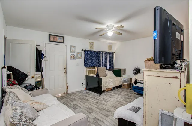 a bedroom with a bed couch and a window