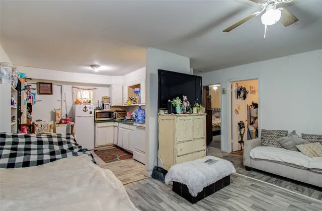 a living room with furniture and kitchen view