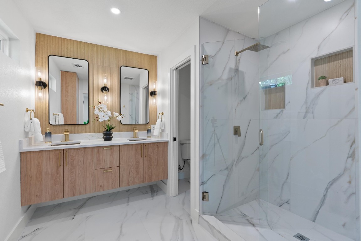 5604 Overbrook Drive Austin, TX 78723 - Photo 24 of 34 a bathroom with a double vanity sink mirror and shower