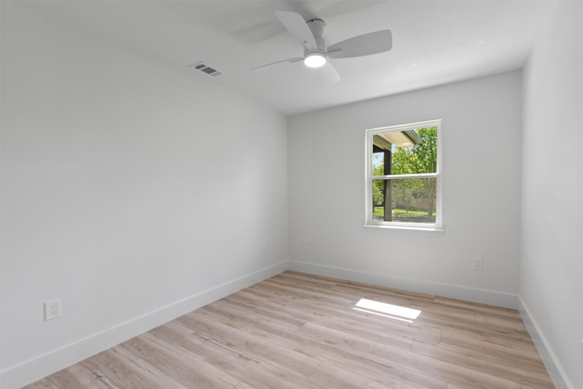 5604 Overbrook Drive Austin, TX 78723 - Photo 31 of 34 an empty room with a window and ceiling fan