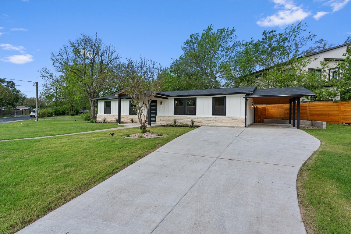 5604 Overbrook Drive Austin, TX 78723 - Photo 7 of 34 a front view of a house with a yard and trees