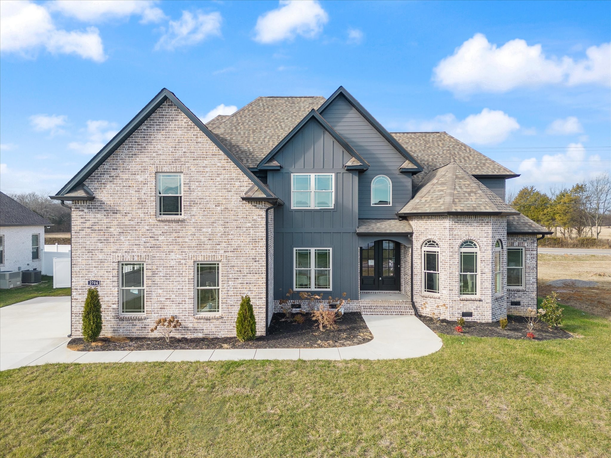 a view of a house with a yard patio and fire pit