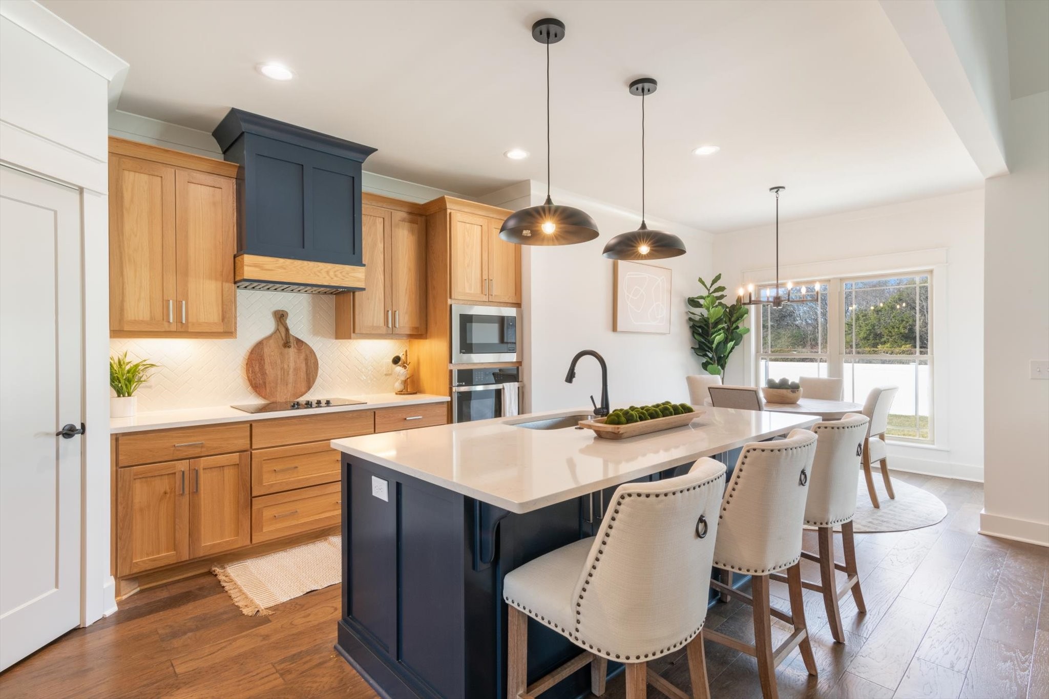 2704 Carousel Drive Murfreesboro, TN 37128 - Photo 4 of 17 a kitchen with stainless steel appliances granite countertop a stove a sink a kitchen island with a dining table and chairs