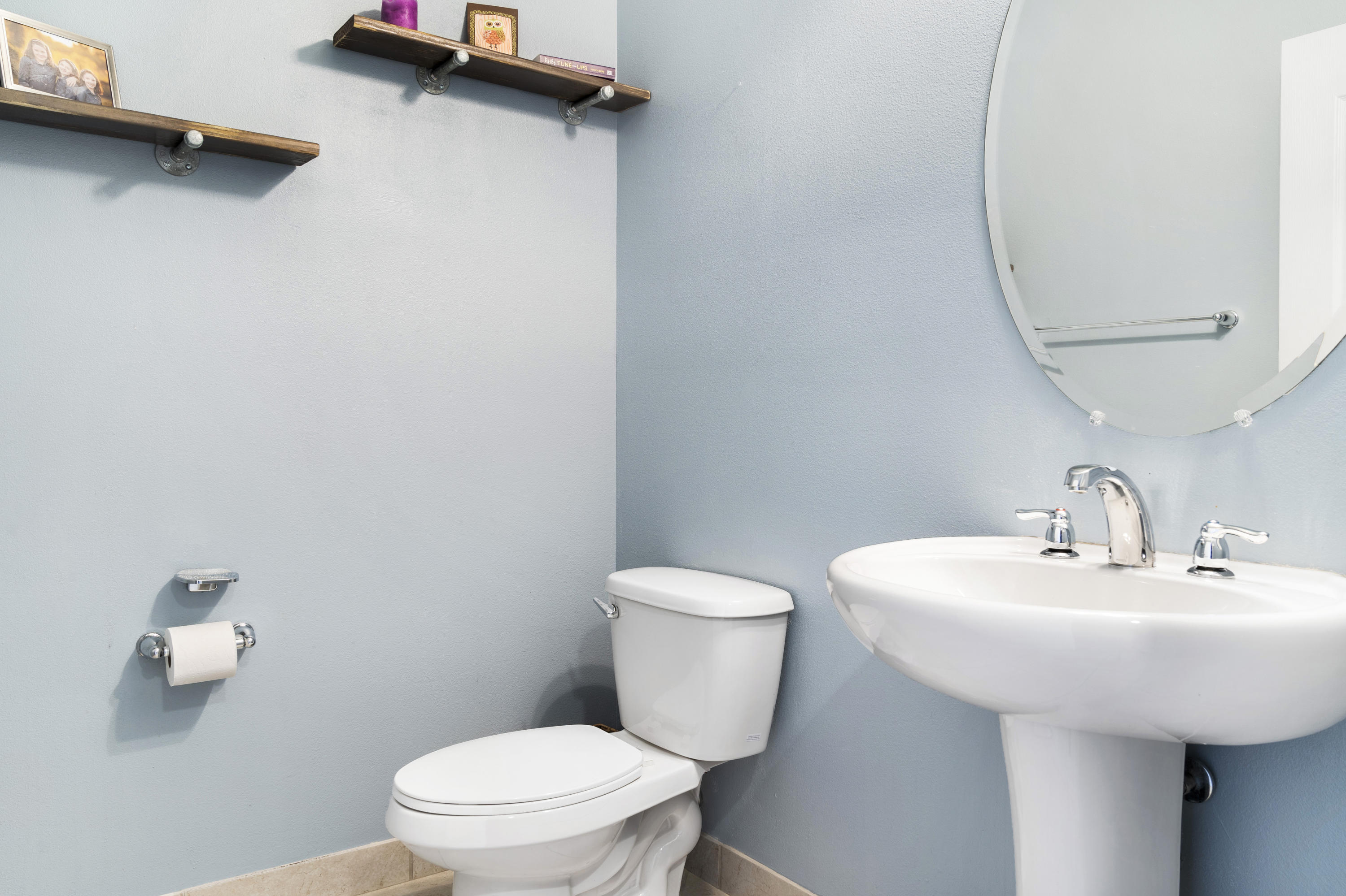 4719 North Prive Circle Delray Beach, FL 33445 - Photo 11 of 23 a bathroom with a sink a toilet and a mirror