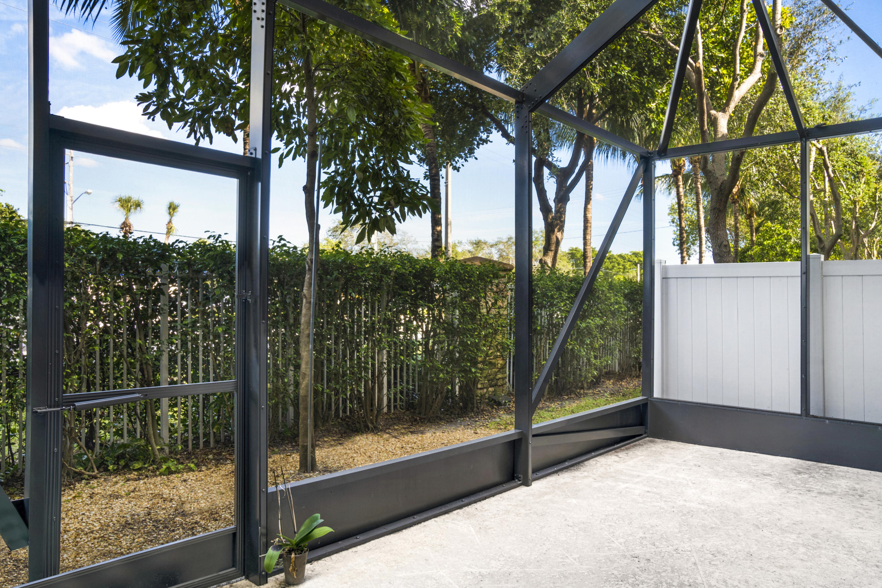4719 North Prive Circle Delray Beach, FL 33445 - Photo 20 of 23 a view of a glass door and a yard