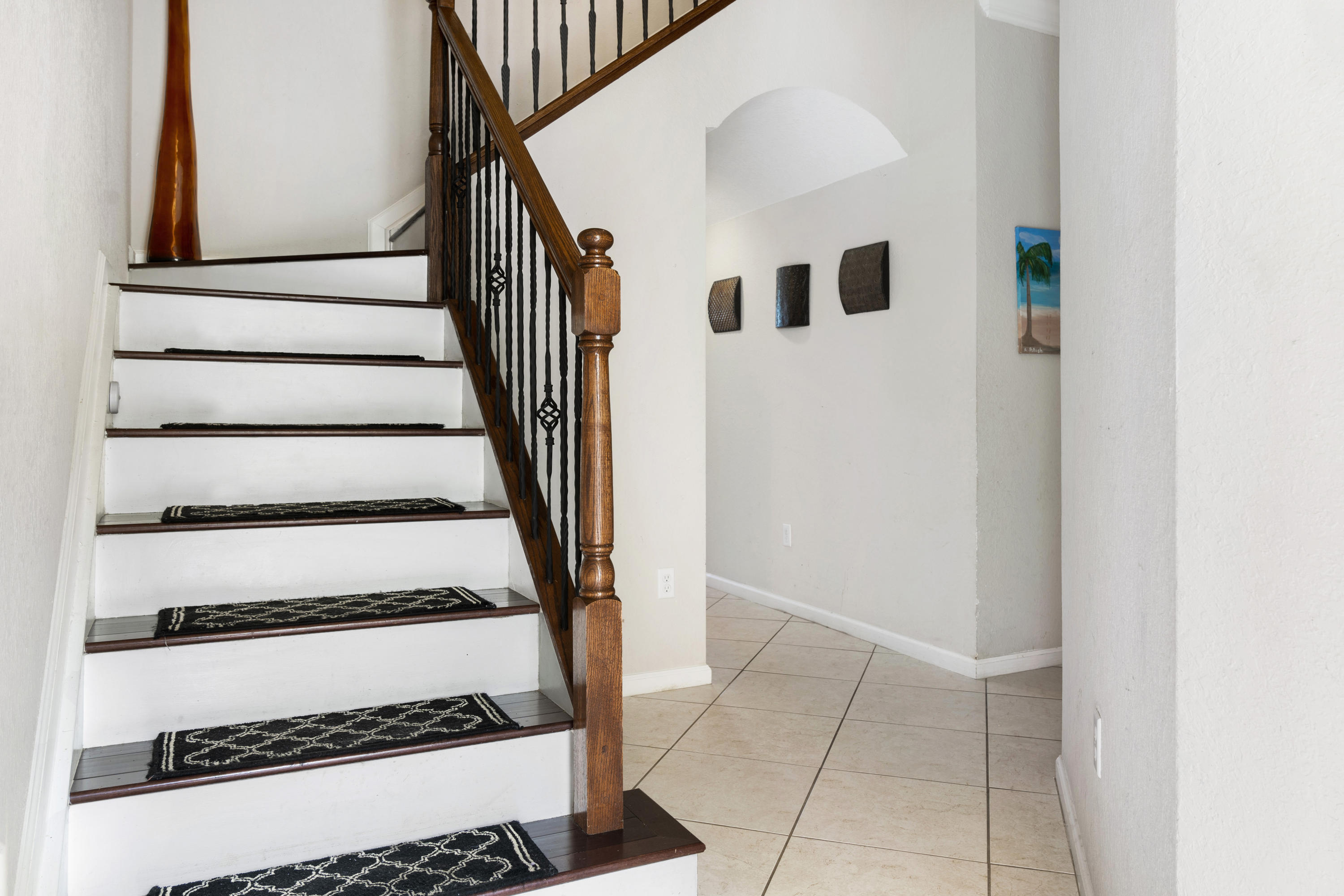 4719 North Prive Circle Delray Beach, FL 33445 - Photo 3 of 23 a view of staircase with white walls and a window