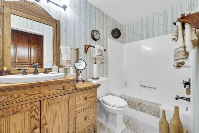 a kitchen with stainless steel appliances kitchen island granite countertop a sink and cabinets