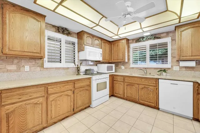 a kitchen with cabinets and refrigerator