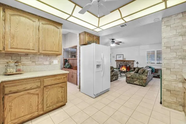 a kitchen with cabinets appliances and a window