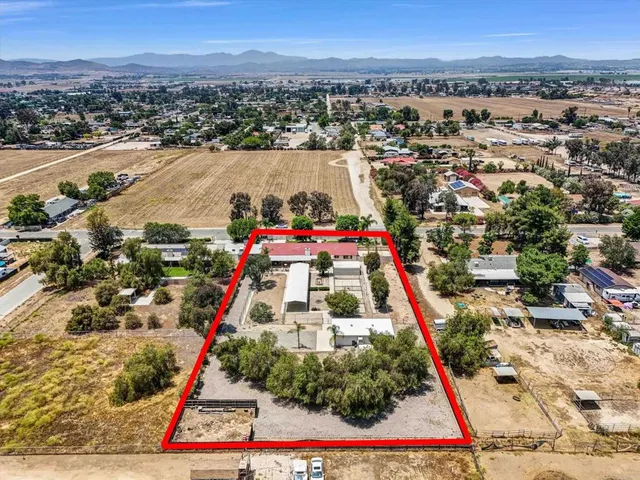 an aerial view of residential houses with outdoor space and seating
