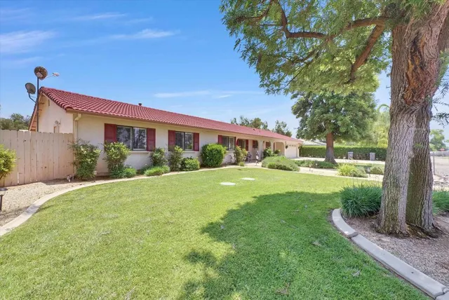 a bedroom with furniture and a flat screen tv