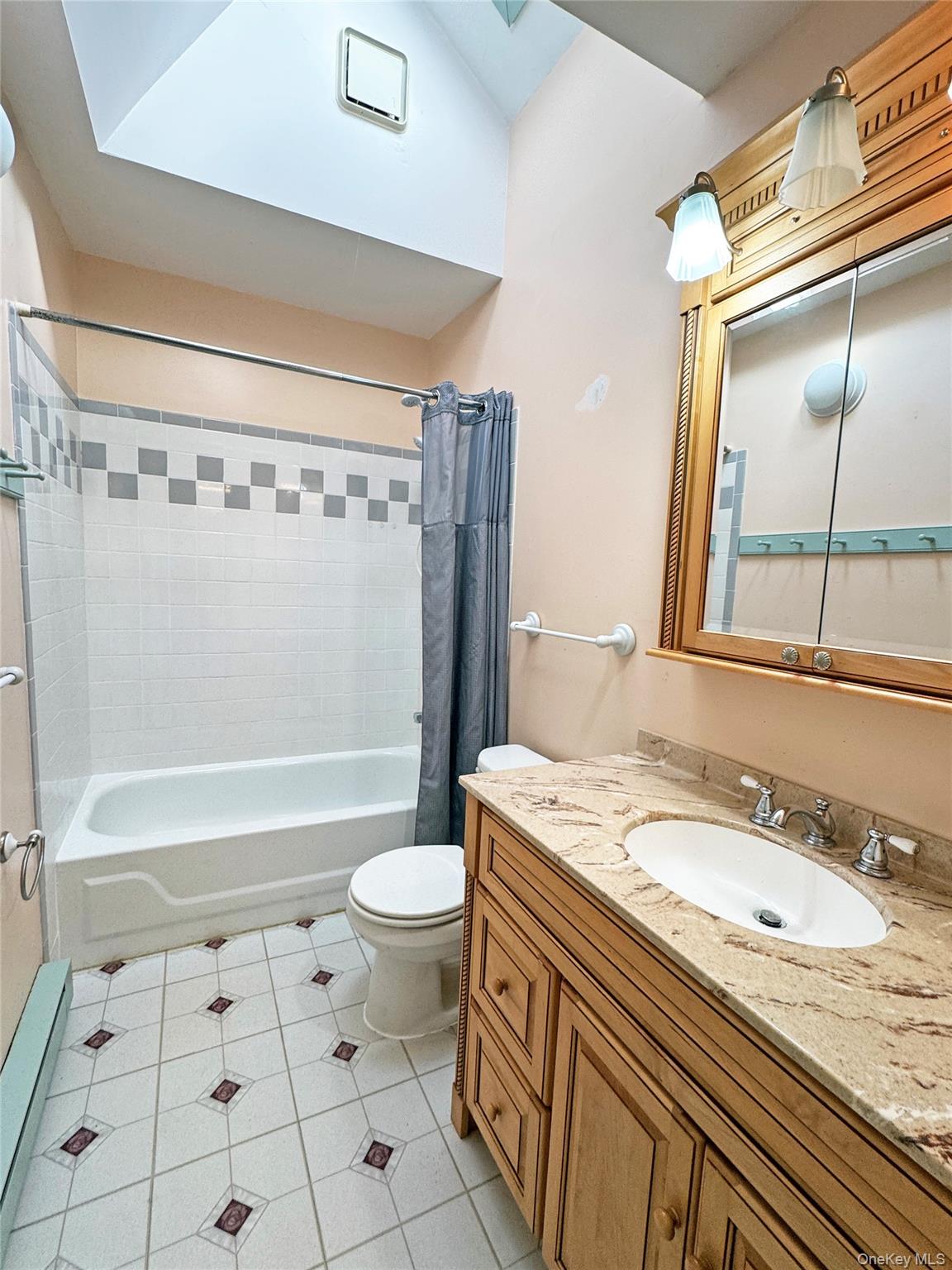 92 Hughson Road Carmel, NY 10512 - Photo 25 of 42 Full bath featuring light tile patterned flooring, shower / tub combo, vanity, and a baseboard radiator
