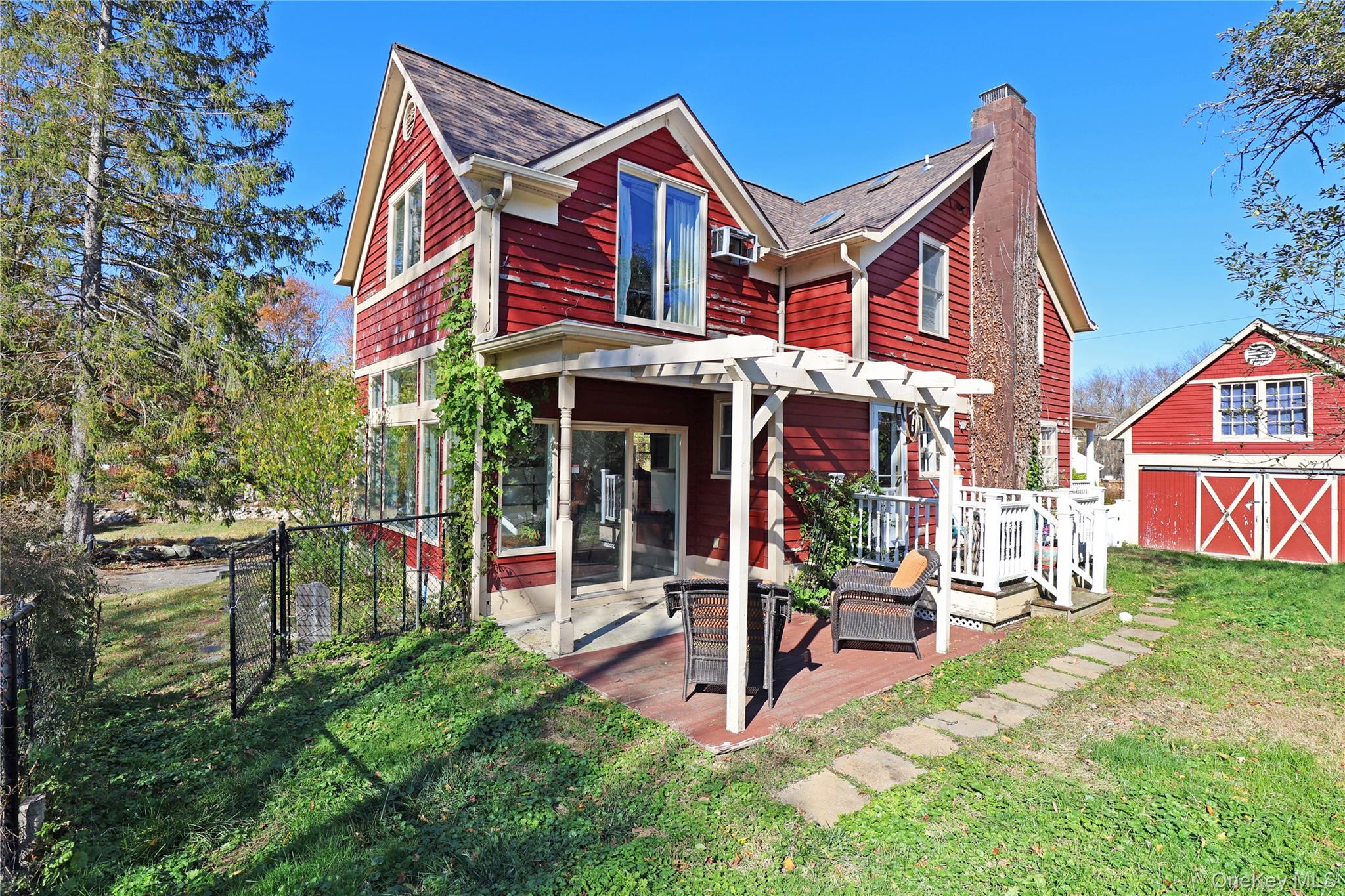 92 Hughson Road Carmel, NY 10512 - Photo 36 of 42 Rear view of property featuring a deck, an outdoor structure, a chimney, a shingled roof, and a gate