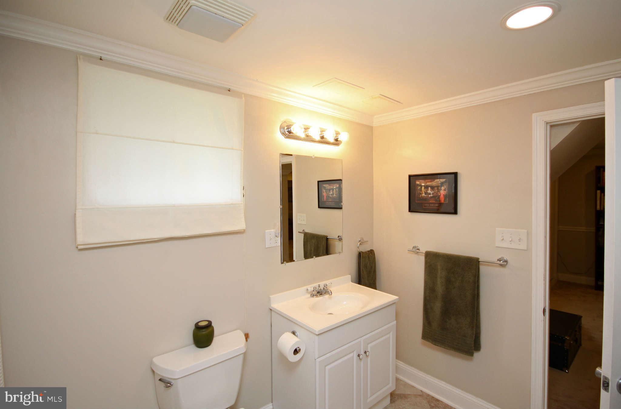 603 Academy Road Baltimore, MD 21228 - Photo 22 of 30 a bathroom with a toilet sink and mirror