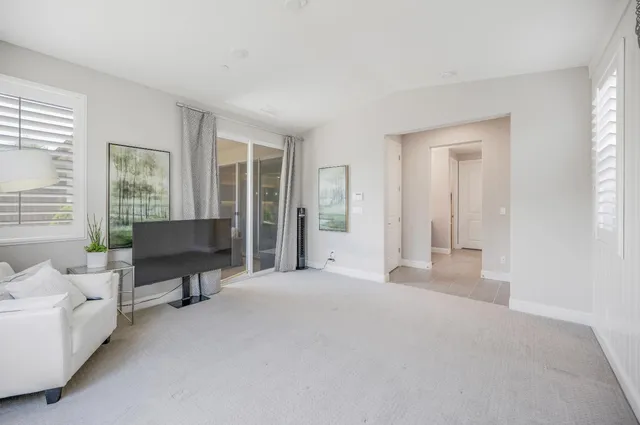 a view of a livingroom with workspace and a window