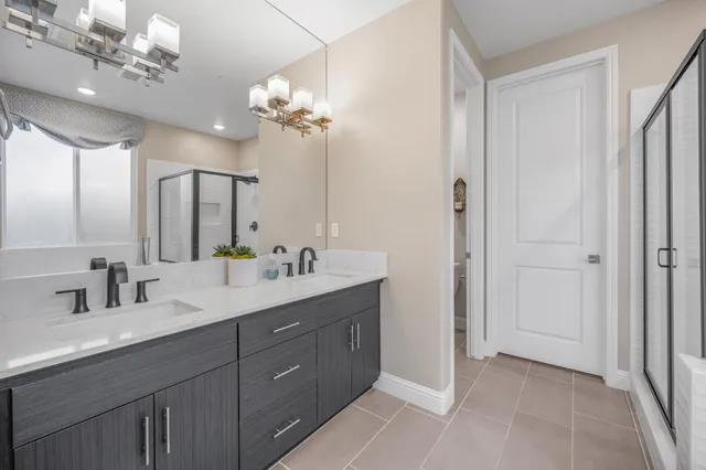 a bathroom with a double vanity sink and a mirror