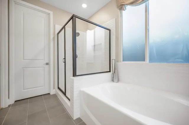 a bathroom with a bathtub and a shower