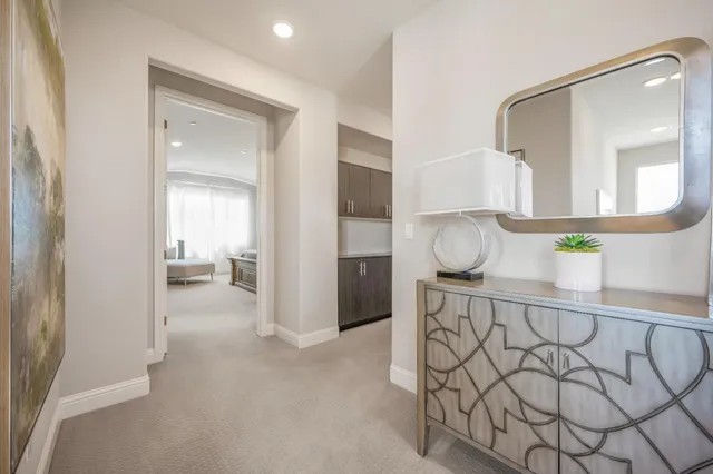 a view of hallway with livingroom and furniture