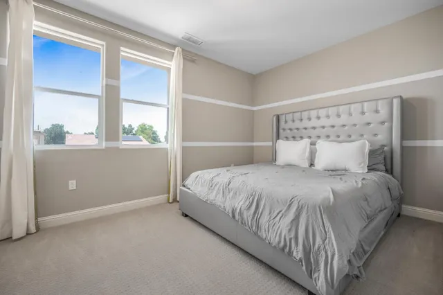 a bedroom with a bed and a window