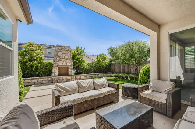 a view of a patio with couches and potted plants