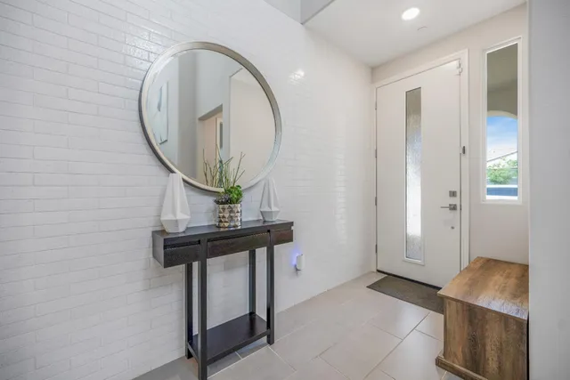 a view of an entryway with sitting space and mirror