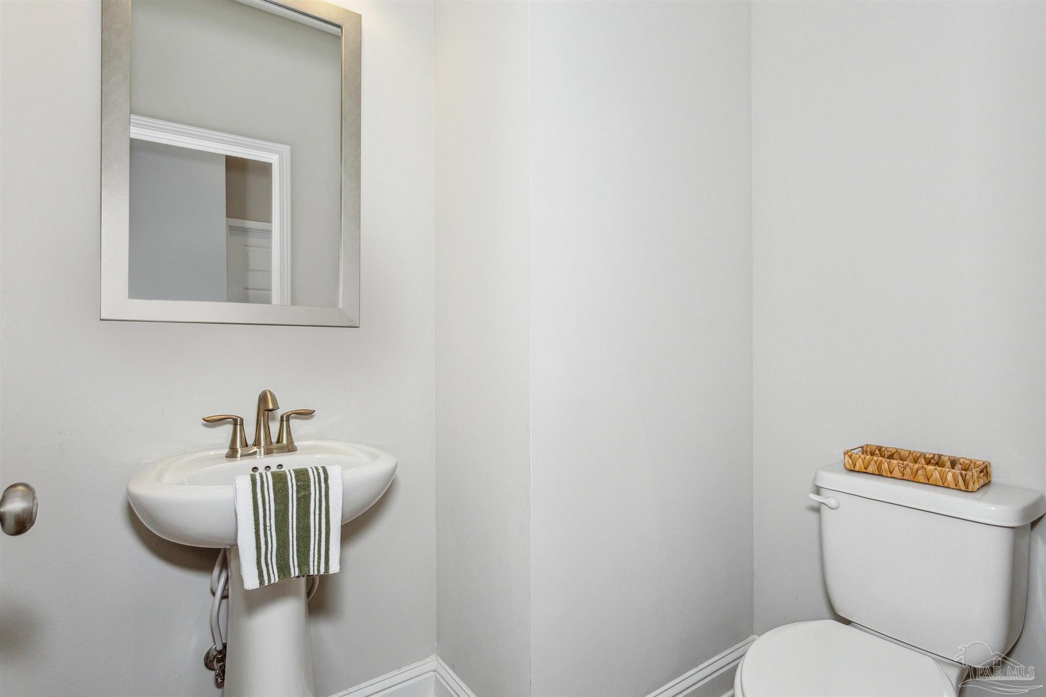 400 Broadleaf Circle Cantonment, FL 32533 - Photo 13 of 21 a bathroom with a toilet sink and mirror