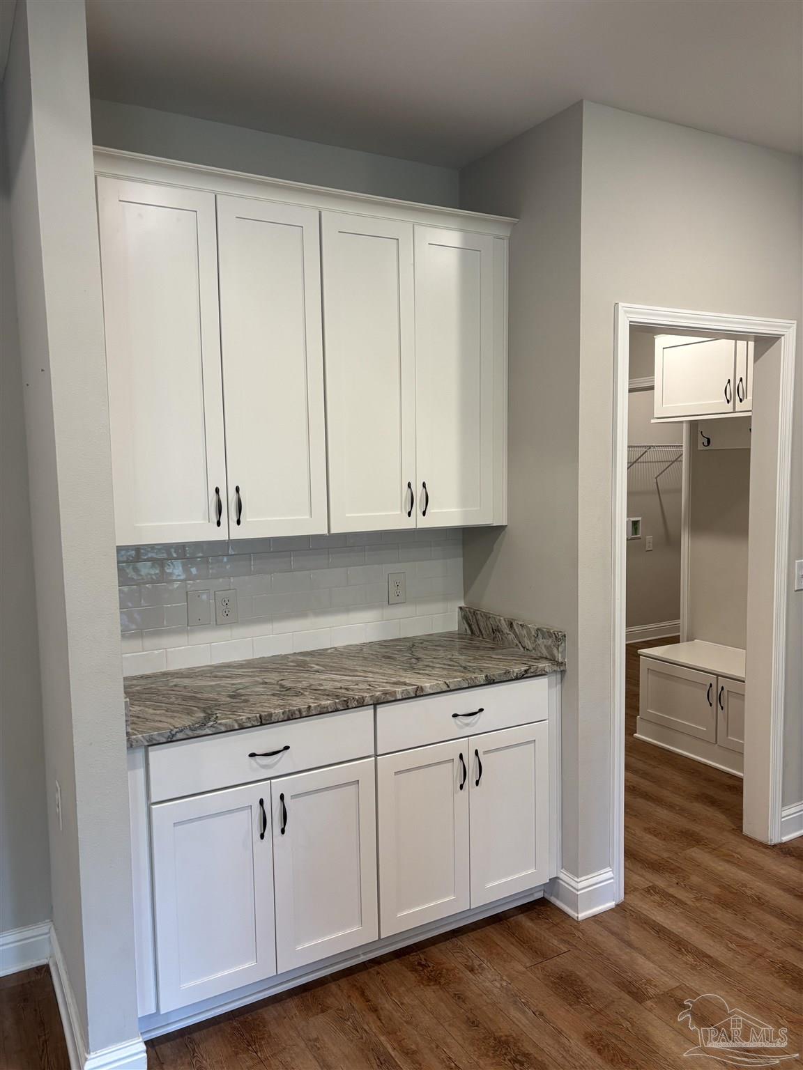 400 Broadleaf Circle Cantonment, FL 32533 - Photo 7 of 21 a kitchen with granite countertop white cabinets and white appliances