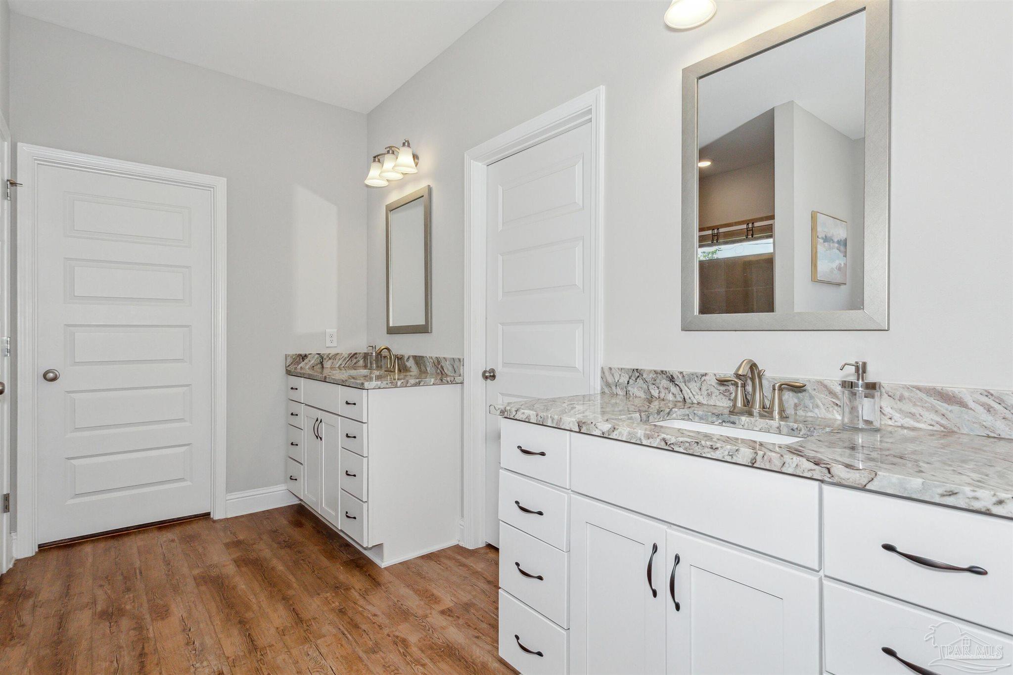 400 Broadleaf Circle Cantonment, FL 32533 - Photo 9 of 21 a bathroom with a sink vanity and mirror