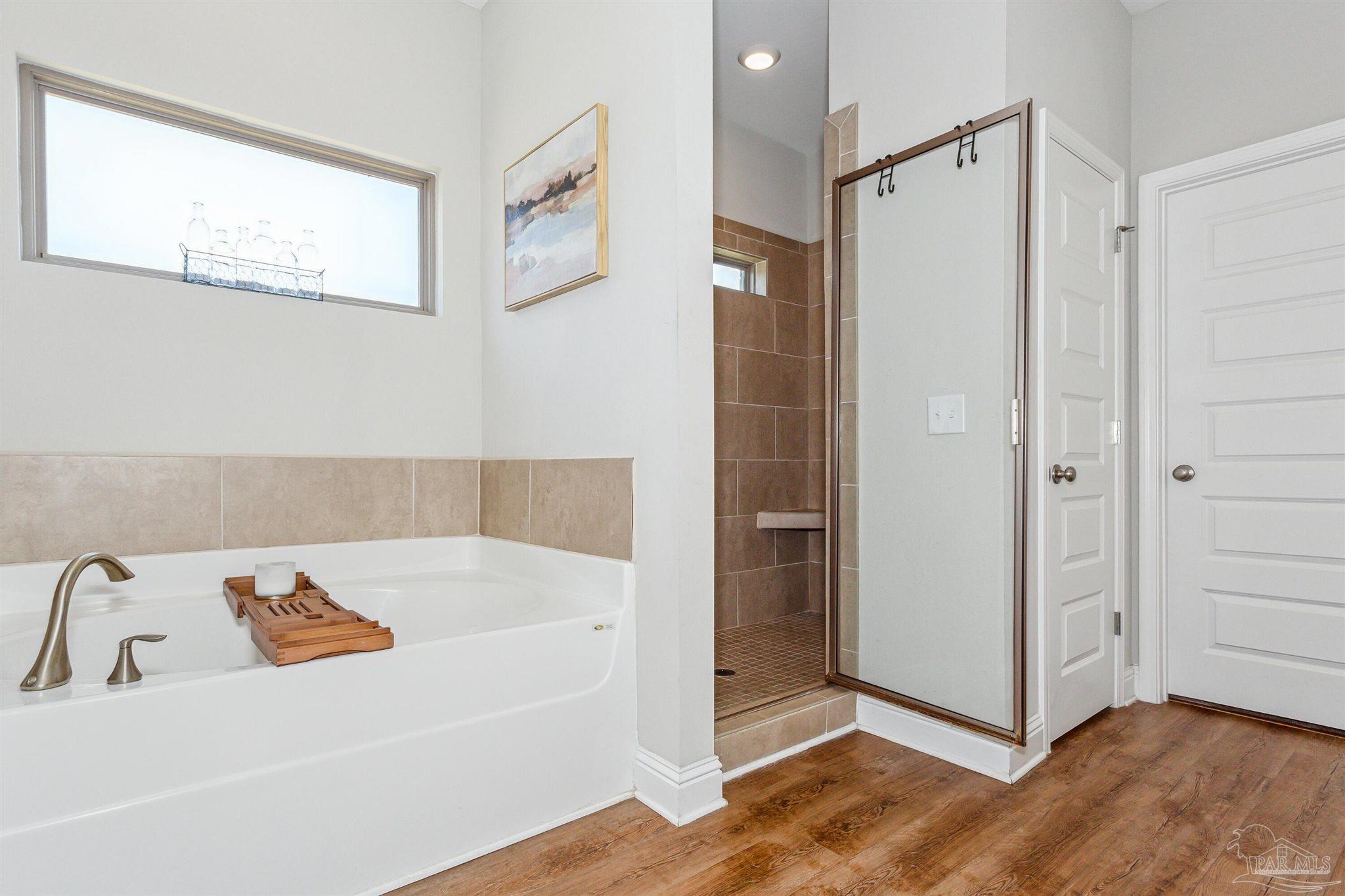 400 Broadleaf Circle Cantonment, FL 32533 - Photo 10 of 21 a bathroom with a bathtub and a shower