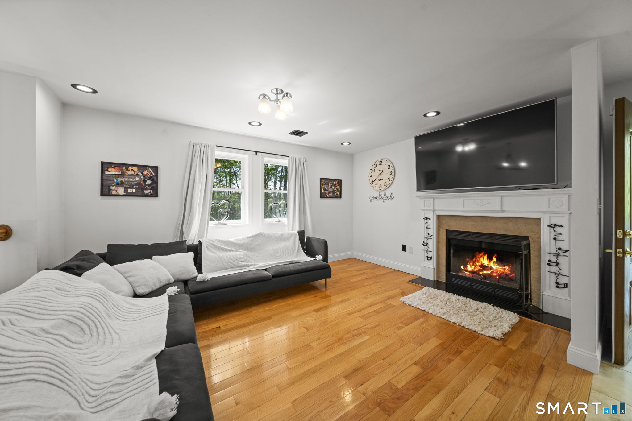 1118 Spindle Hill Road Wolcott, CT 06716 - Photo 15 of 38 a bedroom with a bed and a fireplace