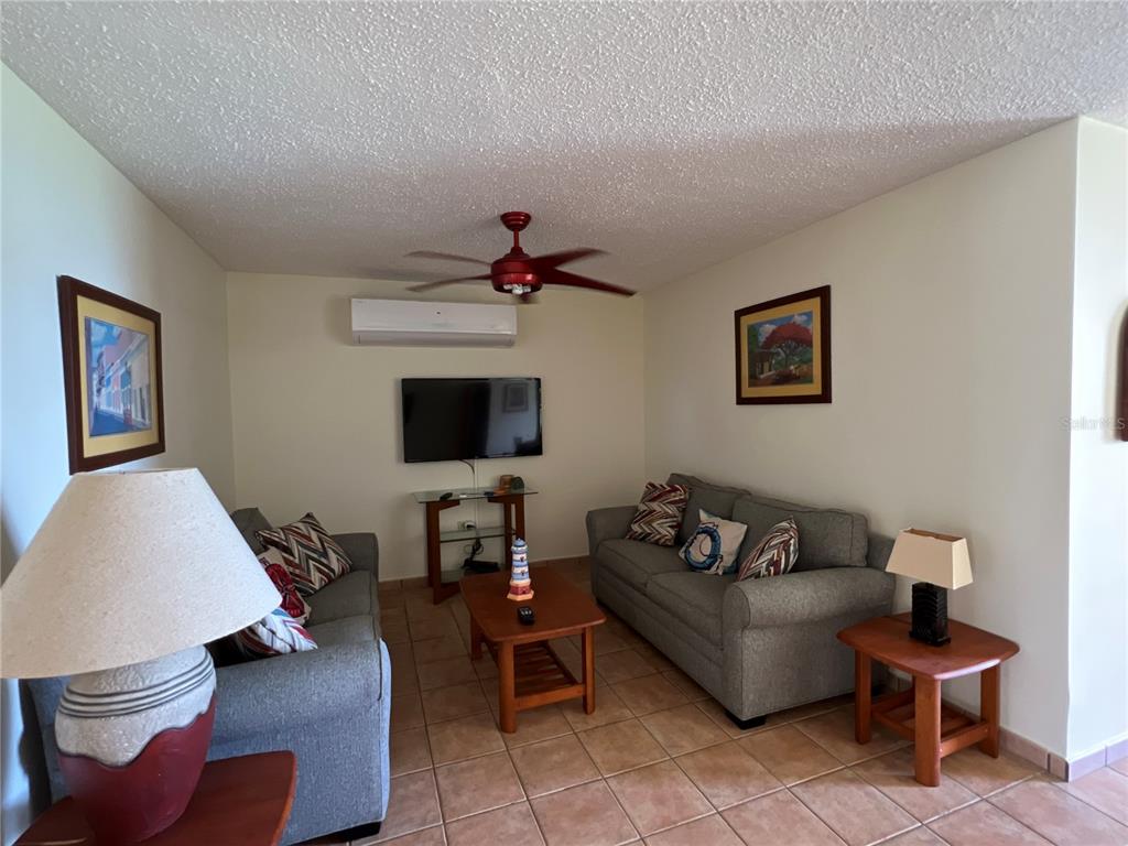 968 Camino Las Picüas, Unit 30 Rio Grande, Río Grande 00745 - Photo 16 of 24 a living room with furniture and a flat screen tv