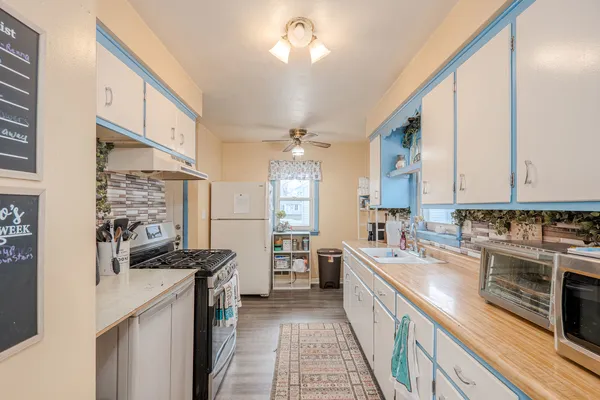 a kitchen with a sink stove and cabinets