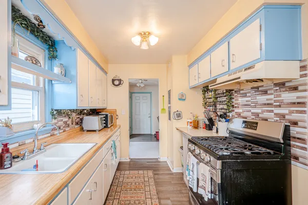 a kitchen with a stove and a sink