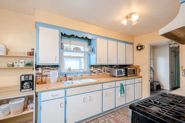 a kitchen with a sink stove and cabinets